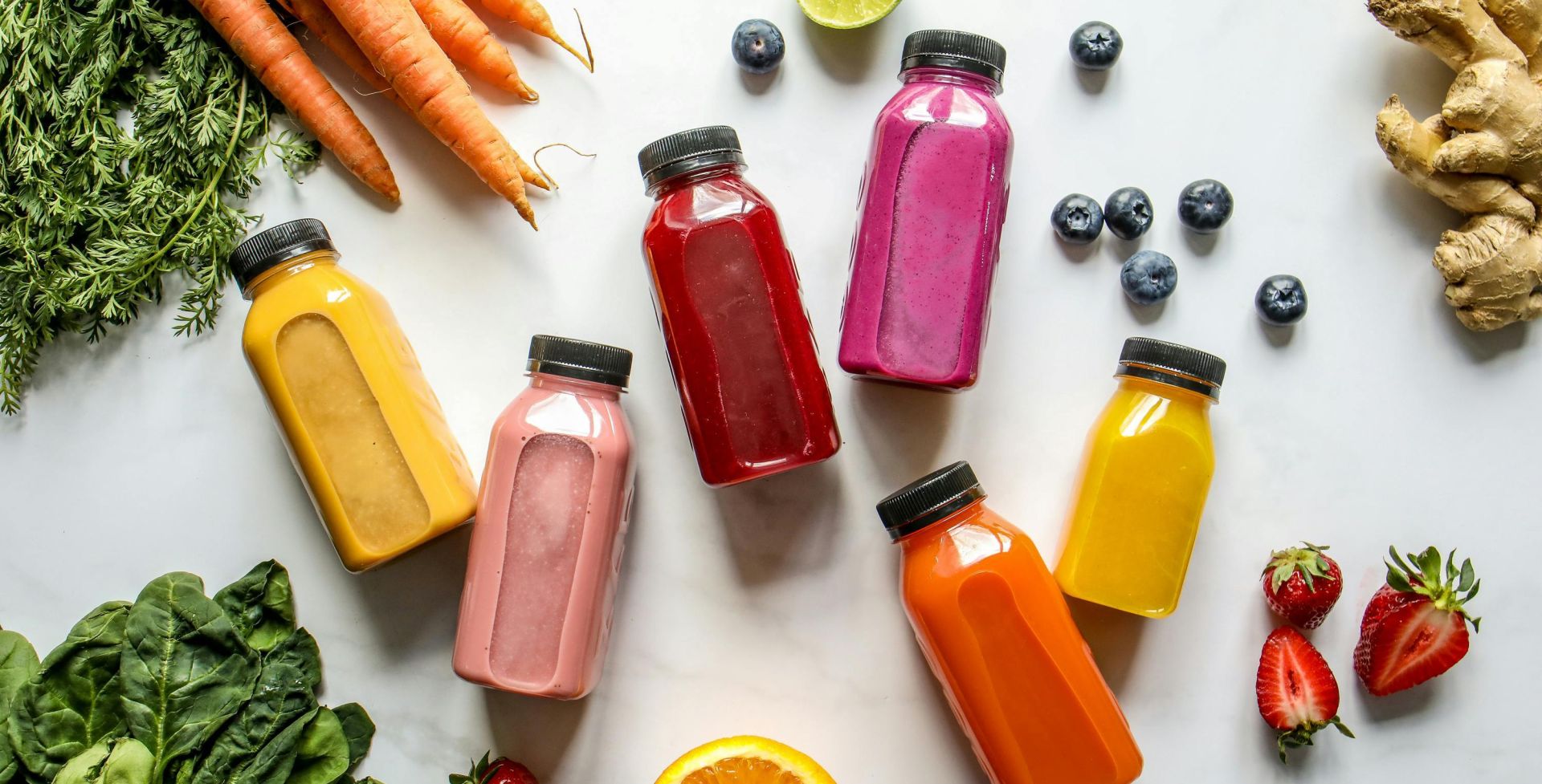 Colorful assortment of organic juices with fresh ingredients for a healthy lifestyle.